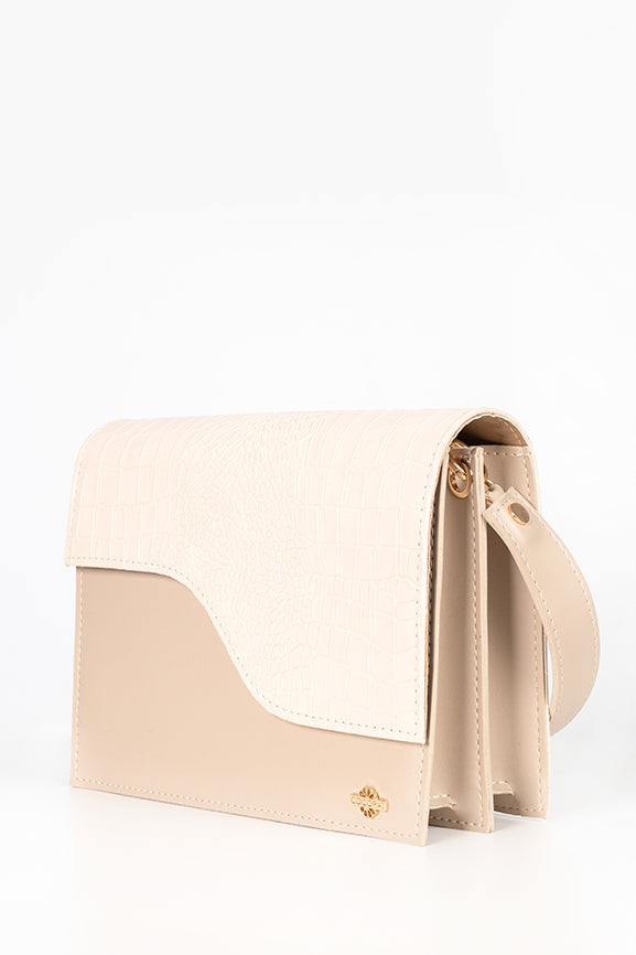 A beige handbag from the front side.